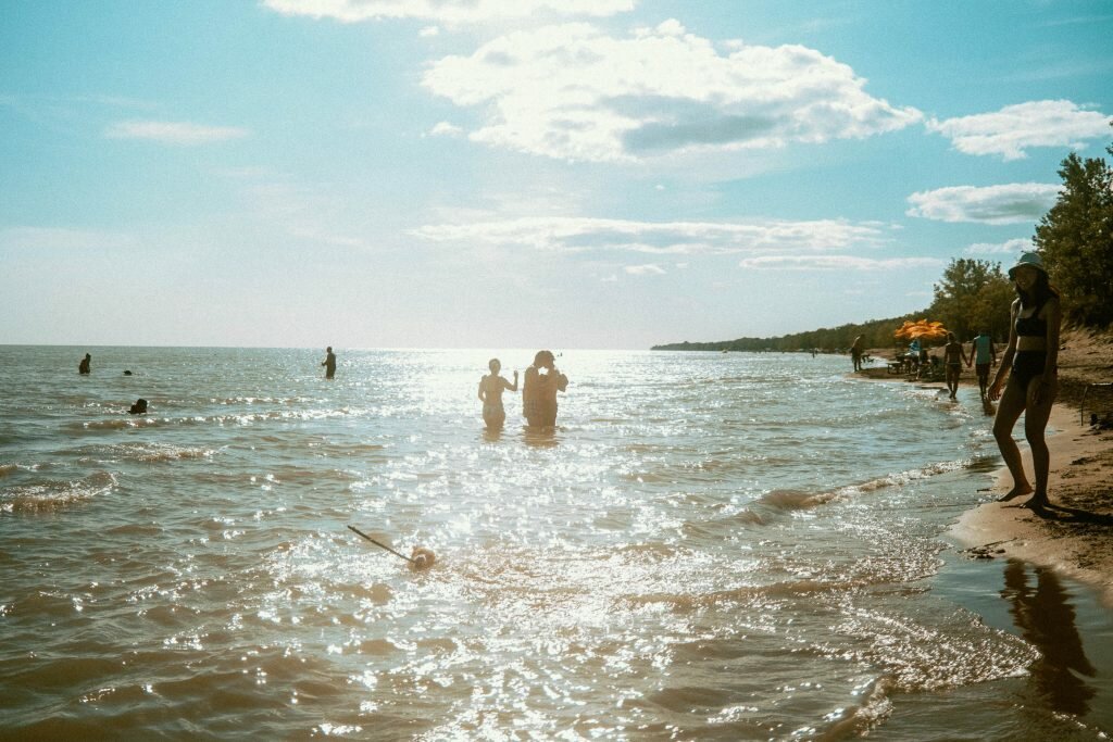 Sunny picture of Lake Erie at Long Point Provincial Park's Dog Beach. In the image, you can see that the lake is very shallow for several meters in and is easily accessible for wading. 