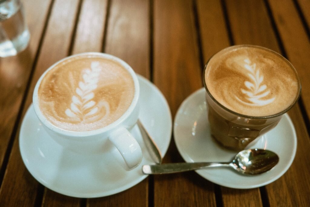 Cappuccino and Cortado on a wooden table at Mildred's Temple Kitchen
