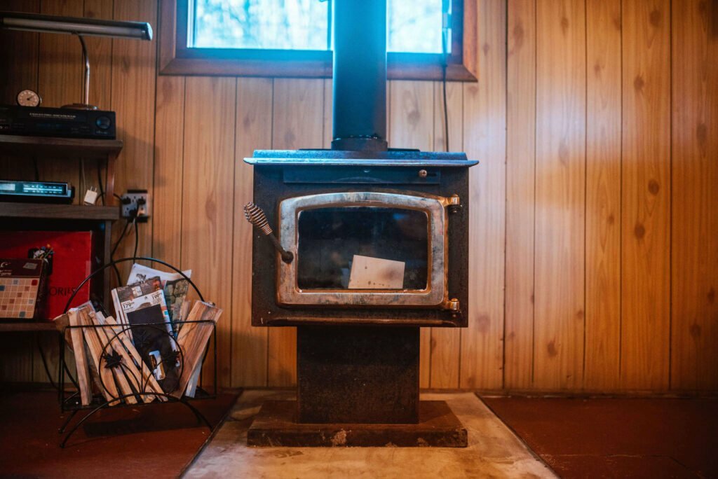 Wood furnace in the rustic cozy cabin in Minden, Ontario. This Hipcamp Canada listing is heated with a wood stove and an electric heater to ensure the cabin remains toasty warm during the fall and winter season