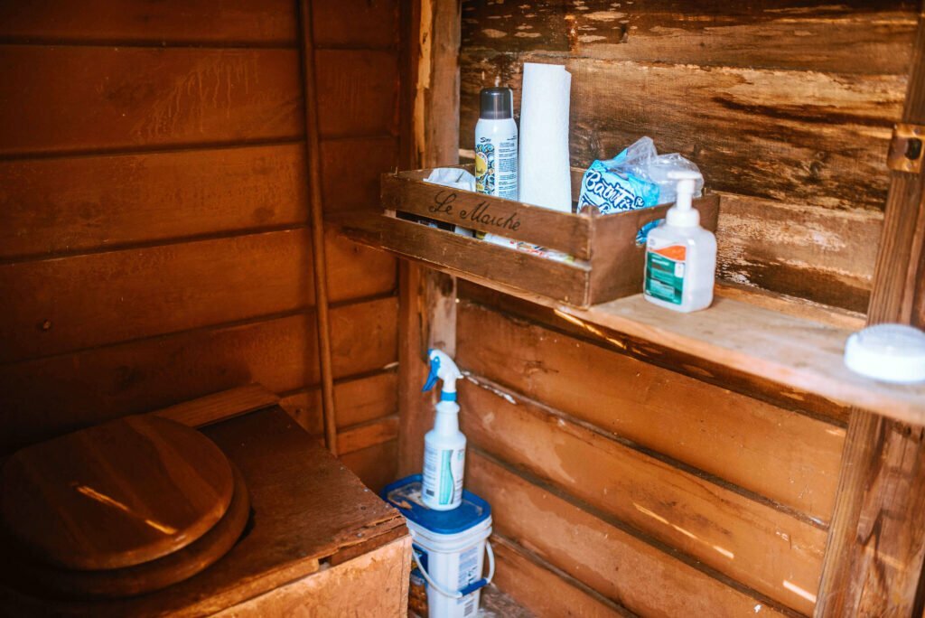 The interior of the outhouse at the rustic cozy cabin in Minden, Ontario - Hipcamp Caanada listing
